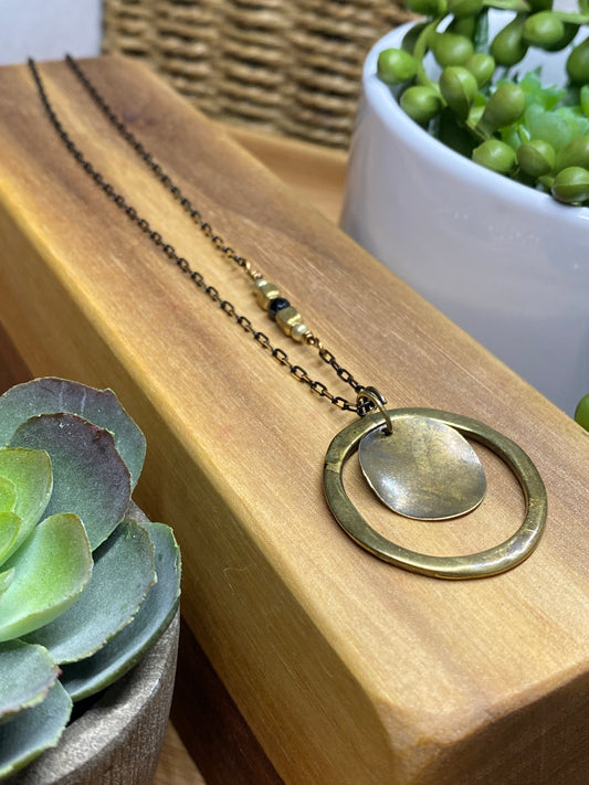 Necklace -36” Full Circle Brass Ring on a black brass faceted chain